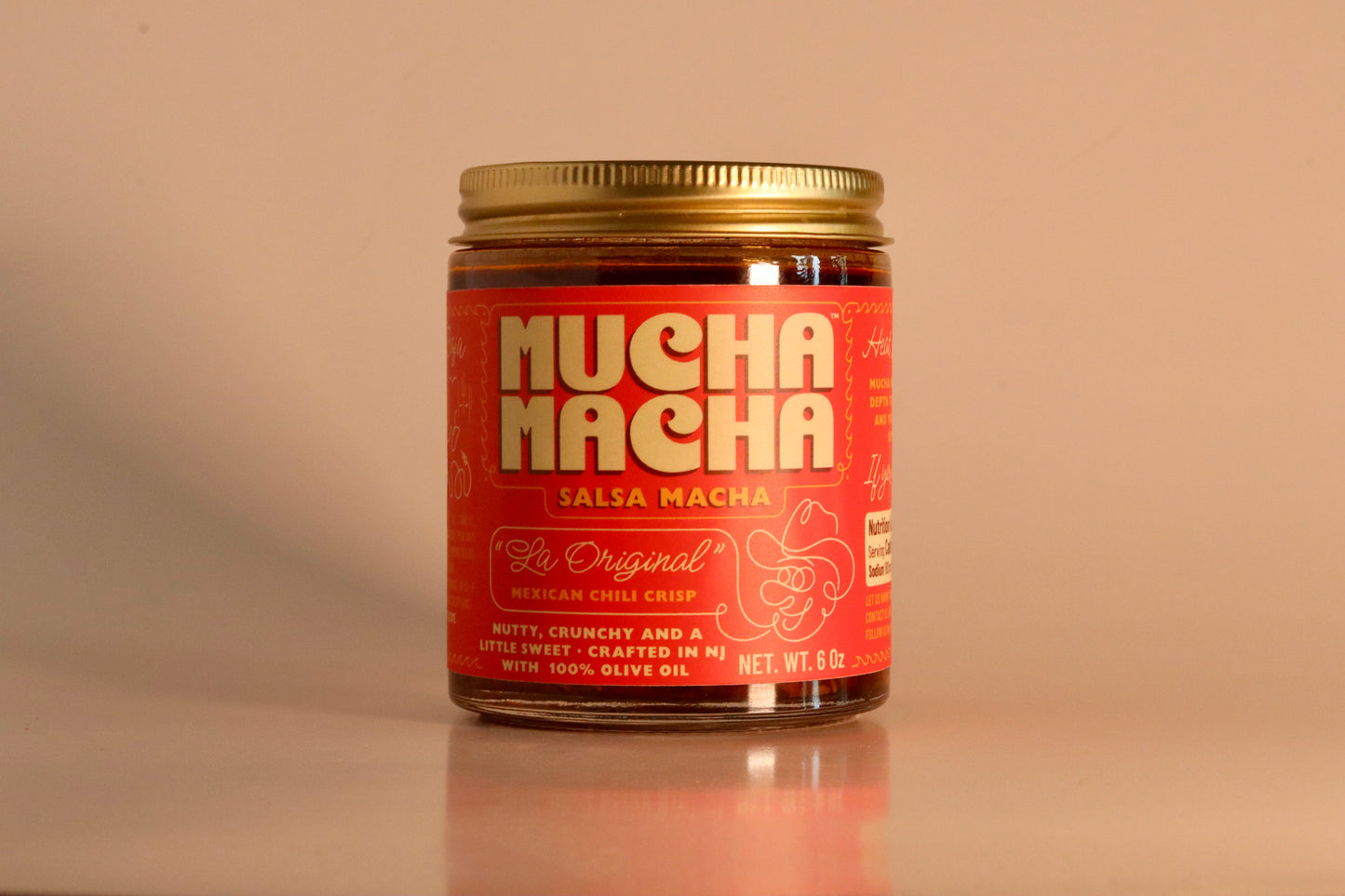 Jar of 'Mucha Macha' salsa on a beige background