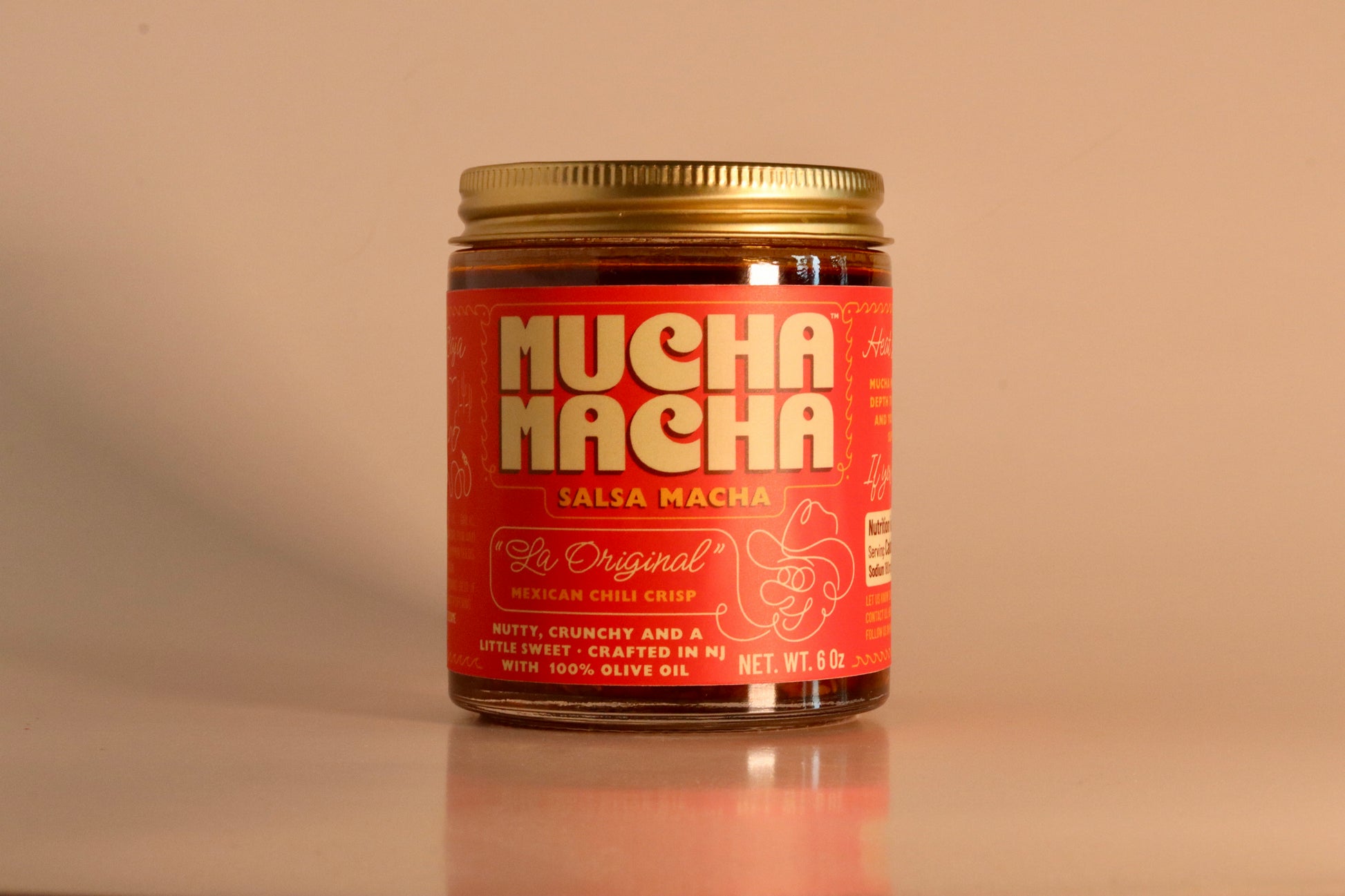 Jar of 'Mucha Macha' salsa on a beige background